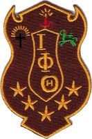 Iota Phi Theta Shield Iron-On Patch [Brown - 2.875"]