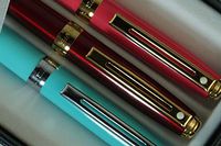 Sheaffer Signature Prelude Lightning Pearlescent Signature Trio of Hot Pink with 22KT Gold, Red with 22KT Gold and Turquoise with Nickel Medium Ballpoint pens.All Adorn Sheaffer Dots of Excellence
