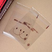 100PCS 10cm x 10cm/3.9'' x 3.9'' Lovely Plastic Transparent Sealing Soap Cookies Candy Bakery Packing Bag Food Grade Biscuits Packing Container (Smiling)